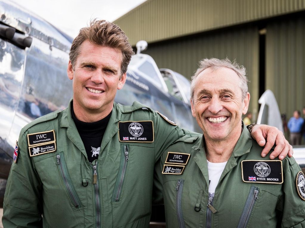 Pilots Matt Jones, left, and Steve Brooks, right, in front of their Silver Spitfire before taking off on their around the world flight in August. EPA / British Ministry of Defence