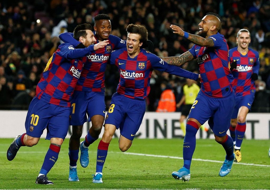 Lionel Messi, left, celebrates with teammates after scoring the winning goal against Granada on Sunday - New manager Quique Setien's first game in charge. EPA