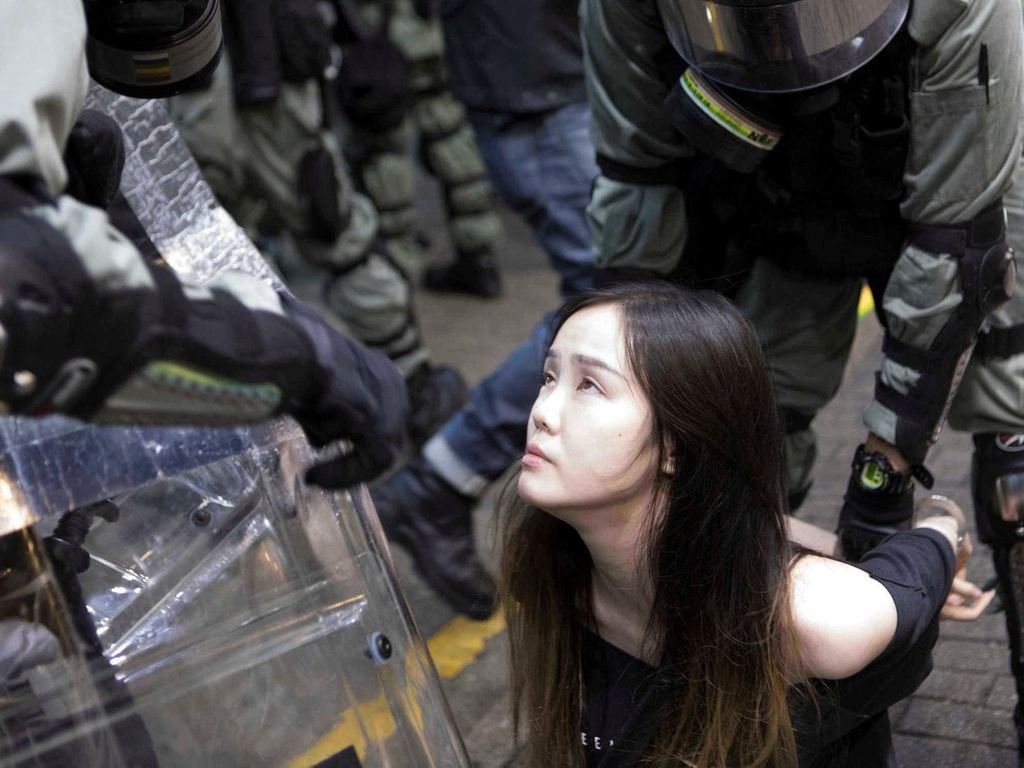 A young female demonstrator is arrested by police during clashes in the Causeway Bay area of Hong Kong. Rick Findler for The National