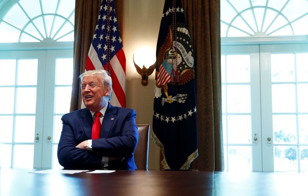 US President Donald Trump laughs during a roundtable meeting with energy sector CEOs in the Cabinet Room of the White House in Washington April 3, 2020. — Reuters pic