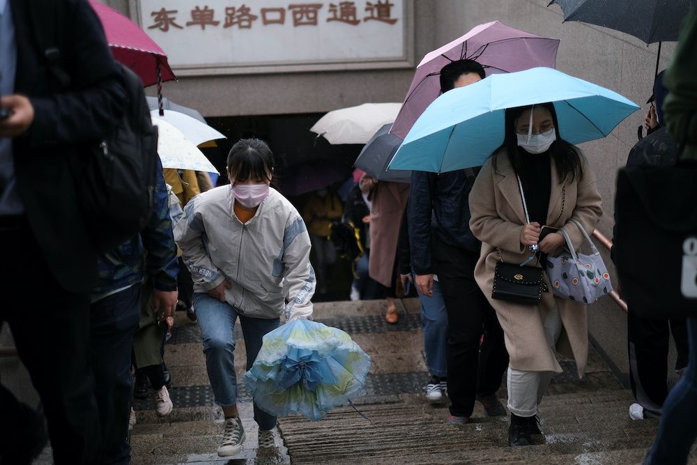 People wearing face masks exit a subway station during a rainy day, following an outbreak of the coronavirus disease, in Beijing, China May 8, 2020. — Reuters pic