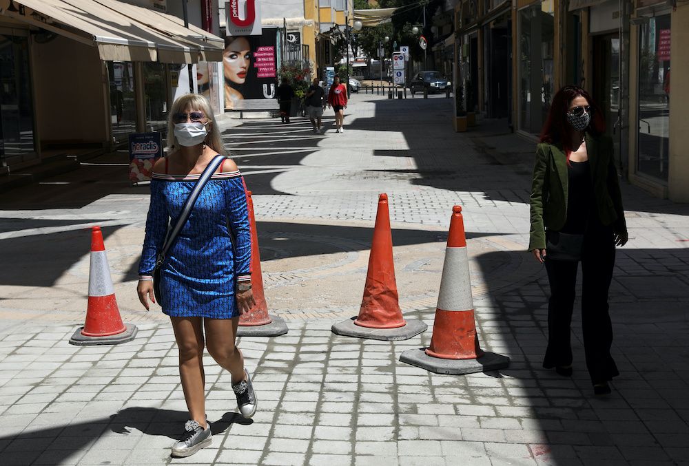 People wearing protective masks walk on the first day of easing of the nationwide lockdown against the spread of the coronavirus disease, in Nicosia, Cyprus, May 4, 2020. — Reuters pic