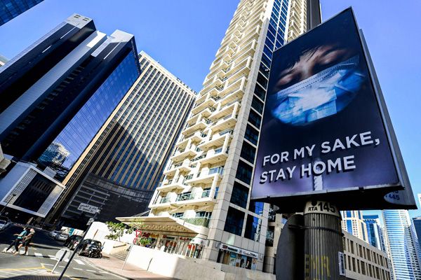 An advertisement in a street in Dubai, advising residents to remain at home due to the COVID-19 coronavirus pandemic. (AFP)