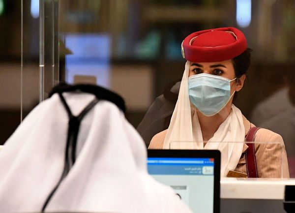 A stewardess of an Emirates Airlines flight from London arrives at Dubai International Airport amid the coronavirus pandemic. (AFP)