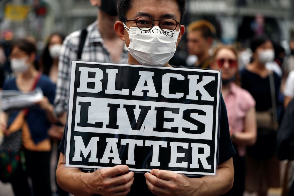 A demonstrator wearing a mask holds a placard during a Black Lives Matter protest, at Shibuya shopping and amusement district in Tokyo, Japan, June 6, 2020. — Reuters pic