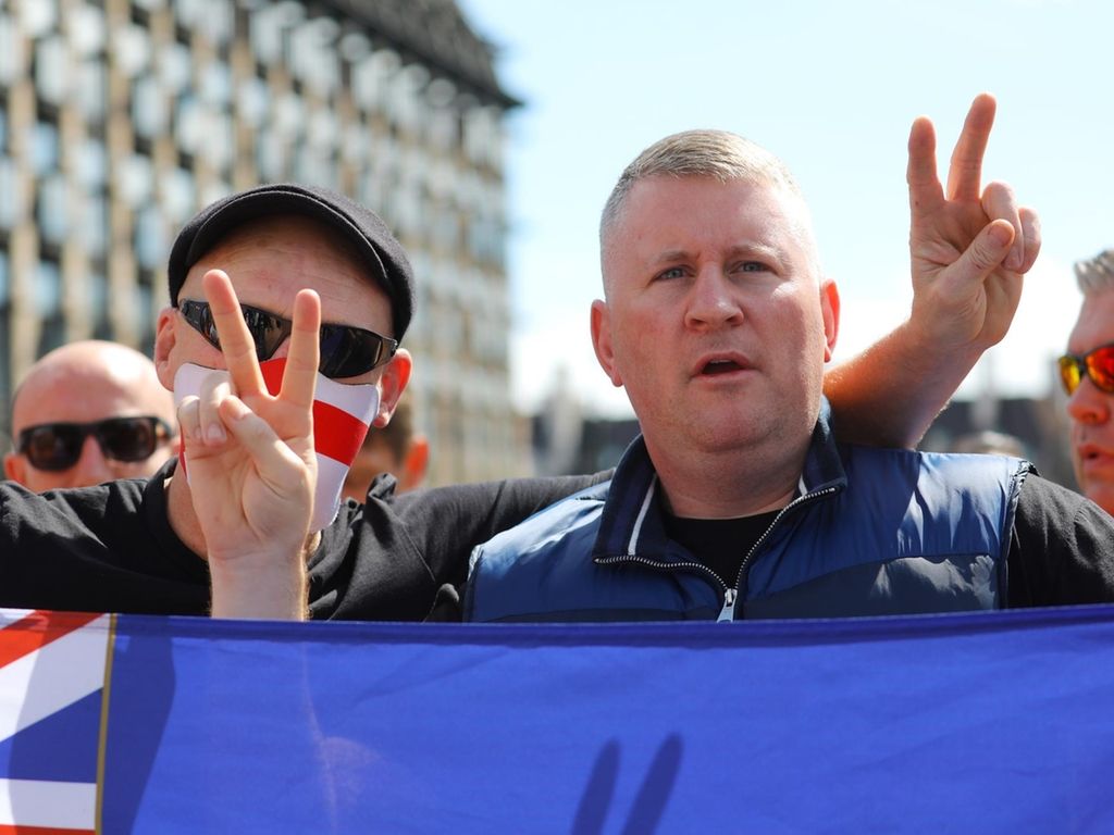 Paul Goulding (R), leader of the far-right political group Britain First stands by the statue of Winston Churchill. EPA