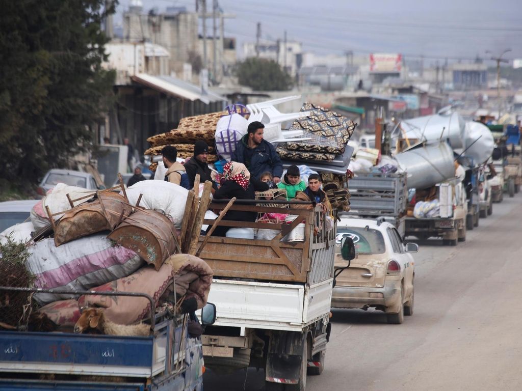 Syrian refugees head northwest through the town of Hazano in Idlib province as the flee renewed fighting Monday, Jan. 27, 2020. (AP Photo/Ghaith Alsayed)