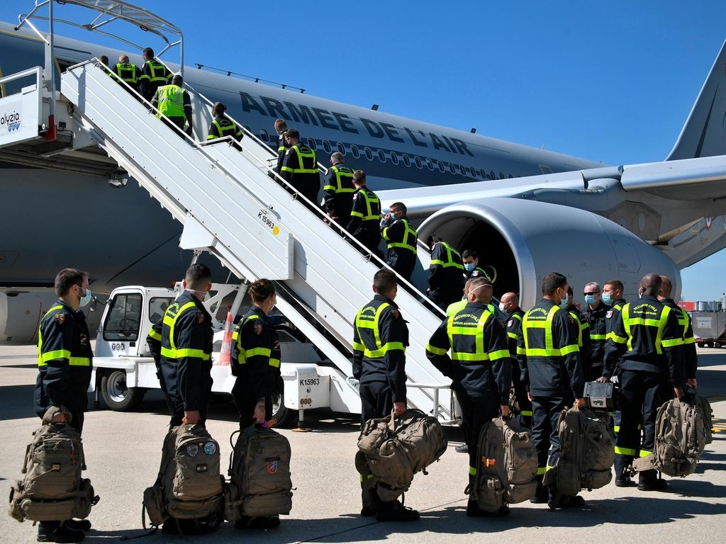 French Securite Civile rescue workers board a military plane at Roissy airport, north of Paris. AP 