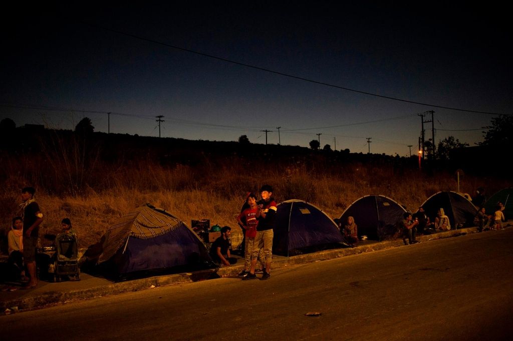 Former Moria camp refugees are now sleeping in roadside tents. AFP