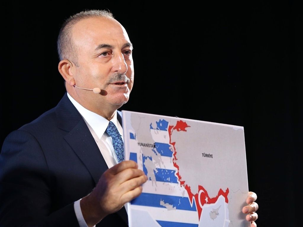 Turkey's Foreign Minister Mevlut Cavusoglu, shows a map of Greece and Turkey as he speaks during a conference in Bratislava, Slovakia. AP