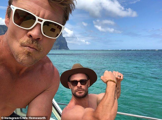 Check out the arms exhibition! He also posted a number of photos from the trip, including a picture of himself showing his bulging biceps with his older brother Luke on a boat off the island's coast