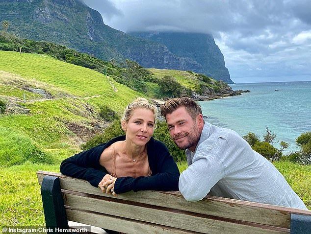 Gorgeous: Chris also shared a cute photo of himself cuddling up to his wife Elsa Pataky with the breathtaking scenery of Lord Howe Island behind