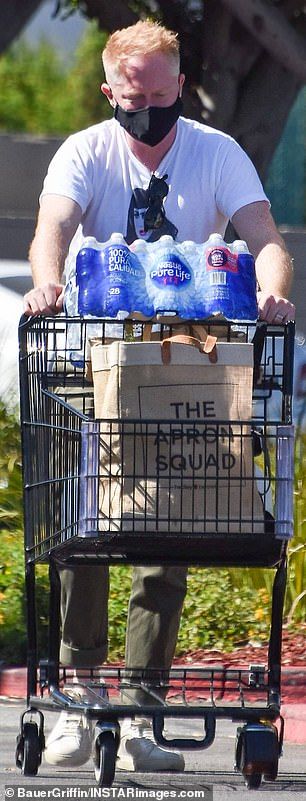 Charging: The couple left the grocery store with a large box of water, several water jugs, and a reusable shopping bag filled to the brim with other goods