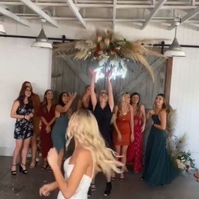 The wedding guest viciously snatches the bouquet from another woman's hand