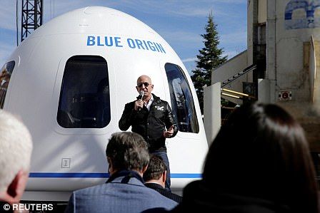 Jeff Bezos in front of the Blue Origin space capsule
