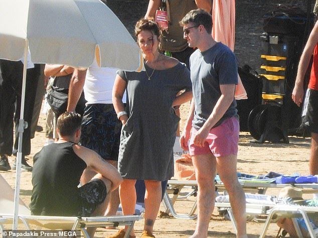 Hunky: Paul, 24, looked typically cool in a gray T-shirt, pink swimming trunks, and signature sunglasses