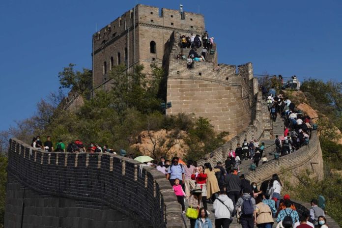 Tourists climb a section of the Great Wall of China from Badaling on the outskirts of Beijing