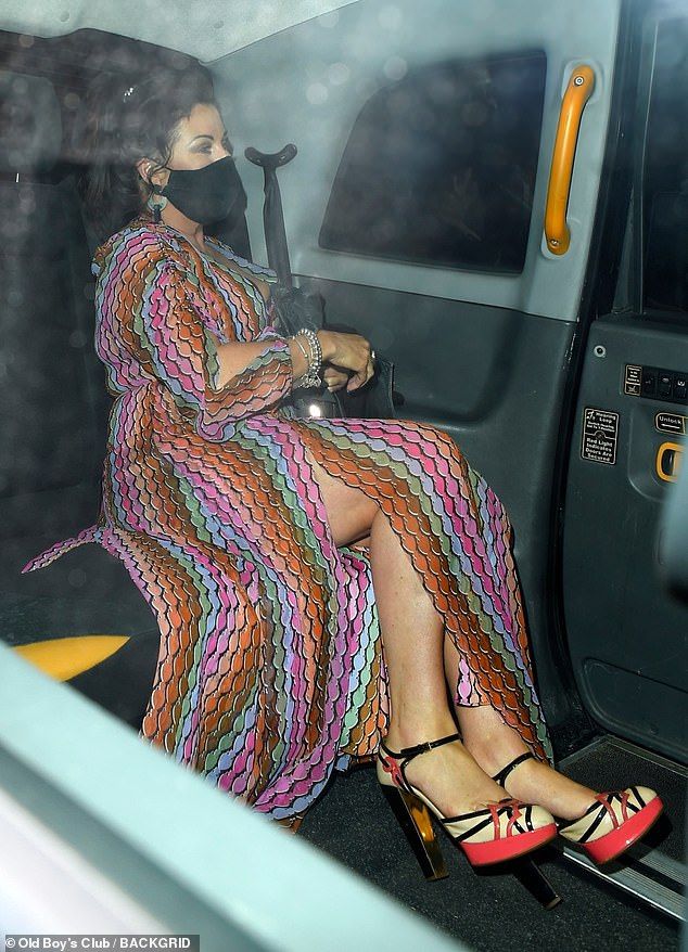 Looks Good: Jessie pulled out all the stops in her stunningly patterned maxi dress that featured a daring breakup. She added a towering pair of platform heels to her look