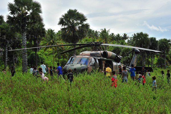 Children gather to take a closer look at an Australian Army Black Hawk helicopter in East Timor.