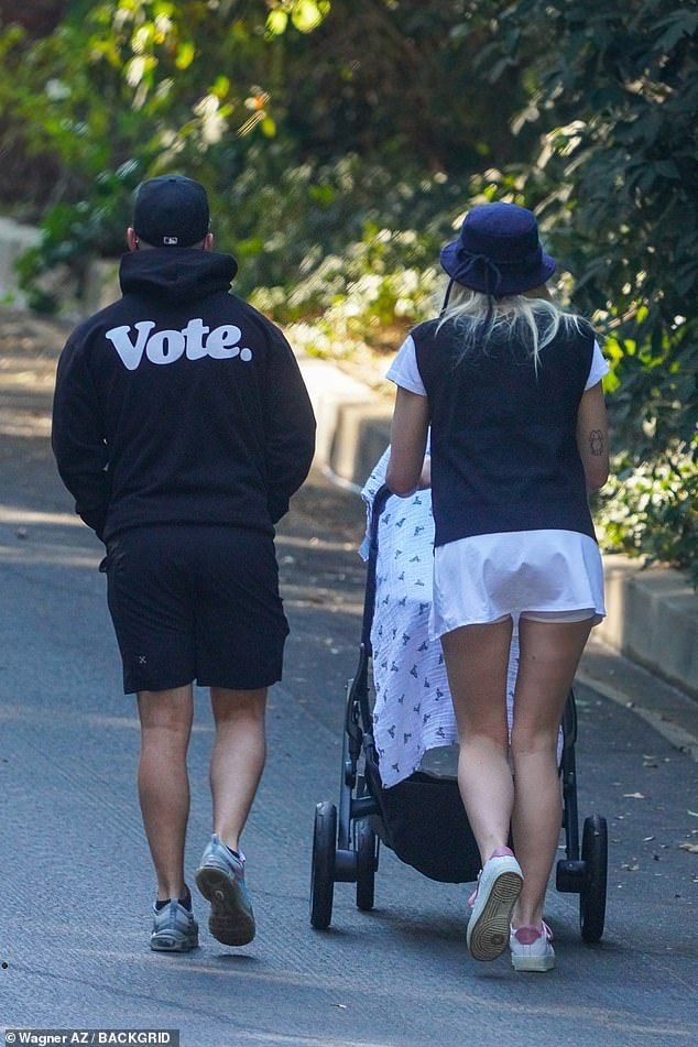 Fashion Statements: The Game Of Thrones actress wore a white mini skirt and black sweater over a white t-shirt while the Jonas Brothers star continued his urge to use his black hoodie to get people to vote in the upcoming US election black shorts