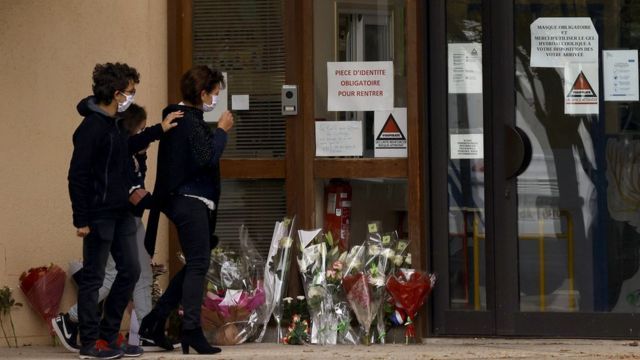Pupils and parents laying flowers at the scene