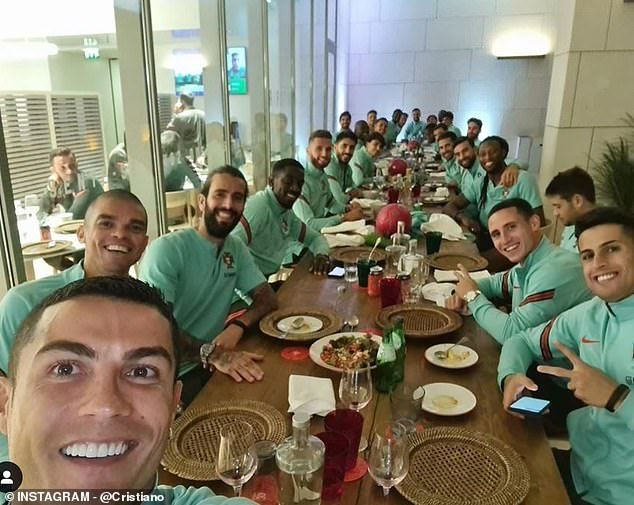 Hours before: Ronaldo (bottom left) posed for a photo with his teammates a few hours before the news broadcast