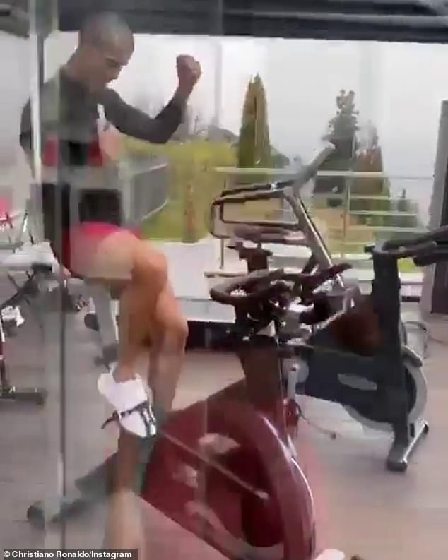 Working out: He then hopped inside to his mordern, glass gym, jumping onto an exercise bike