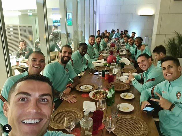Ronaldo poses with his Portuguese teammates just a day before his positive test was revealed