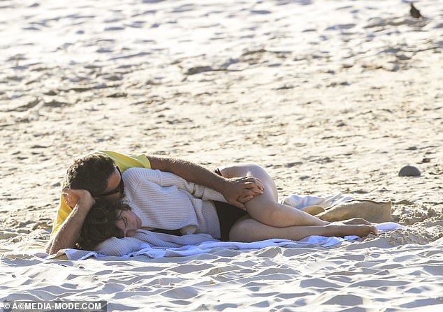 How romantic: the couple held hands and snuggled up on the beach