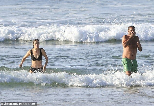 Brr! The couple, who describe themselves as husband and wife but are not legally married, took a refreshing swim and then dried off on the beach