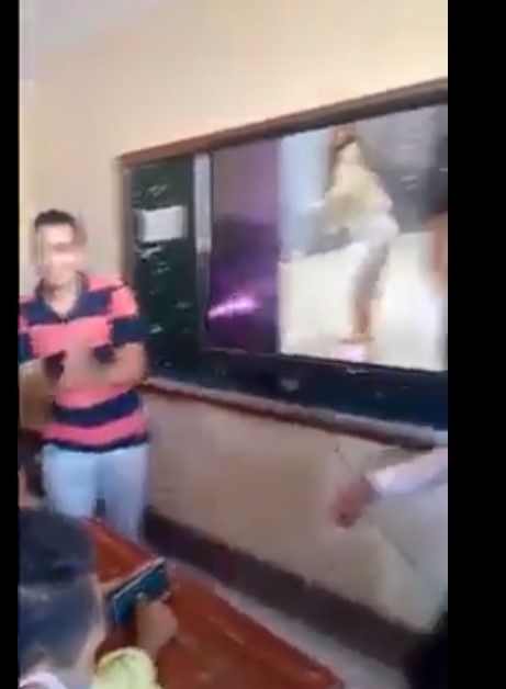 A student claps while viewing the video A student claps while viewing the video