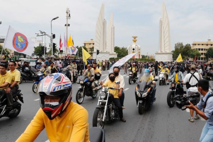 Anti-government protesters move on motorbikes during a rally near the Democracy Monument.