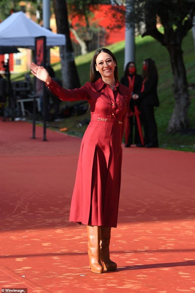 Chic: Dajana was stylish when she slipped into a red long-sleeved dress that had a pleated skirt and a statement belt