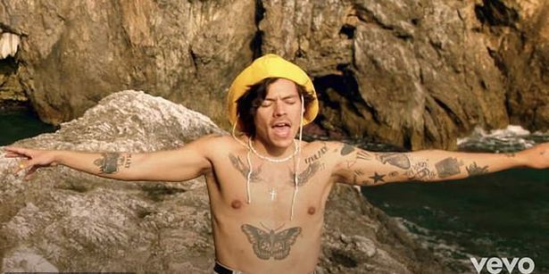 Harry shows off his tattoos