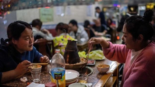 Chinese women eating at a restaurant in Beijing
