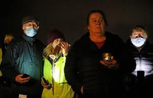 People at a candlelight vigil at the Llewellyn Estate in Ballinteer, south Dublin, after the bodies of a woman and two young children were discovered (Brian Lawless / PA Wire)