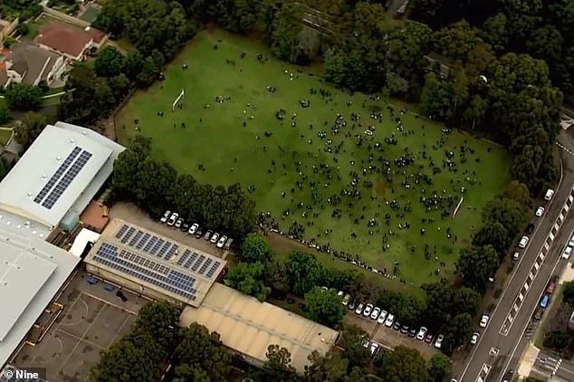It comes after the biology exam was suspended Wednesday morning after numerous New South Wales schools received a threatening email. Pictured: Students on an oval of an evacuated Castle Hill school on Tuesday