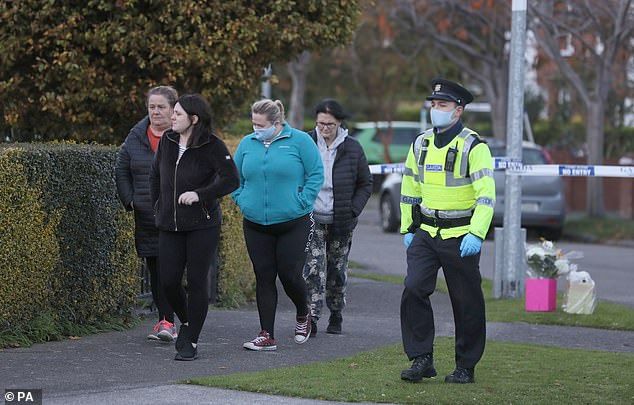 People leave after planting flowers near the scene at the Llewellyn estate in Ballinteer