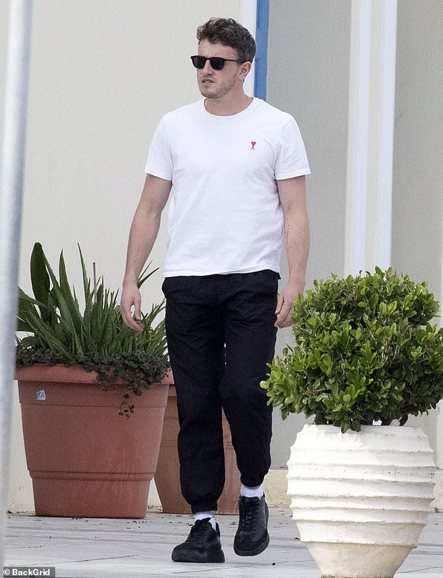 Insert: Wearing a simple white T-shirt and black joggers, Paul, 24, looked relaxed as he strolled through the picturesque Spetses in the Greek islands where he was shooting the new movie The Lost Daughter