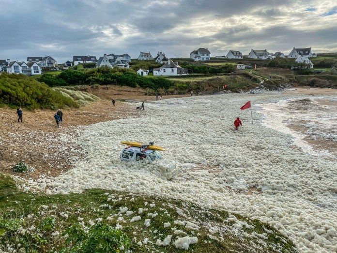 An RNLI 4x4 fell into foam as lifeguards rushed to rescue visitors from a beach