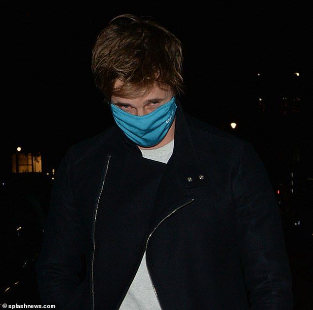 Play it safe: Maura's friend put on a blue face mask for the walk