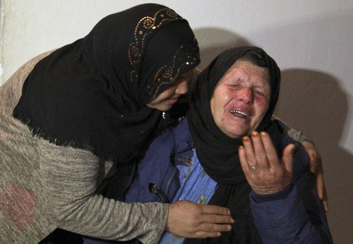 Brahim Aouissaoui's mother is crying in her home in Tunisia