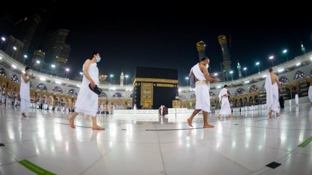 Umrah pilgrims circumambulate the Kaaba while maintaining social distancing and wearing masks