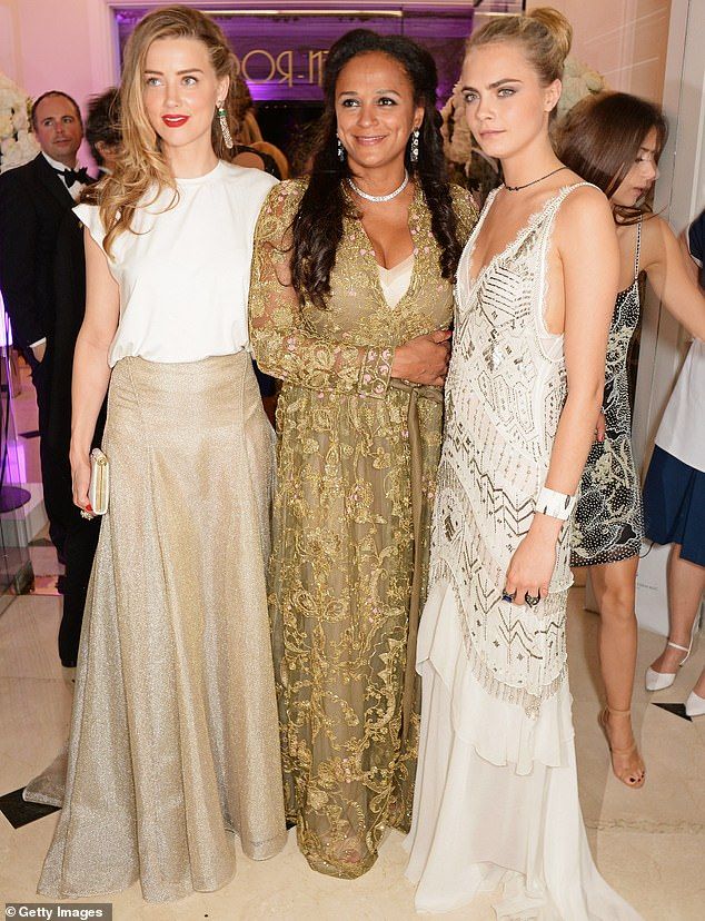 Mrs dos Santos with Amber Heard (left) and Cara Delevingne (right) in Cannes in May 2014