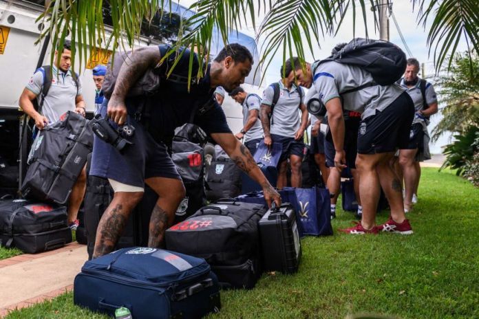 New Zealand Warriors NRL players collect their suitcases after getting off their bus in Terrigal on the central NSW coast.