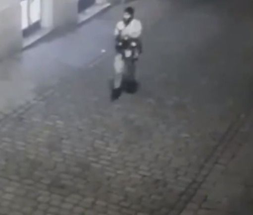 One of the terrorists weighs his gun as he wanders through Vienna