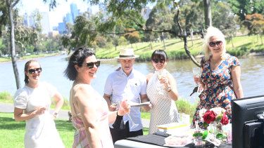 Serina Dowding, Melinda Sutherland, Duncan Macdonald, Christina Ferguson and Helen Vay enjoy Cup Day at Yarra Park Linear Reserve in Melbourne.