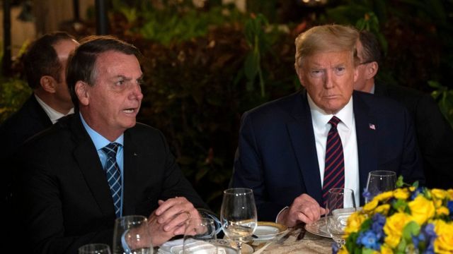 Bolsonaro and Trump dining side by side at a table