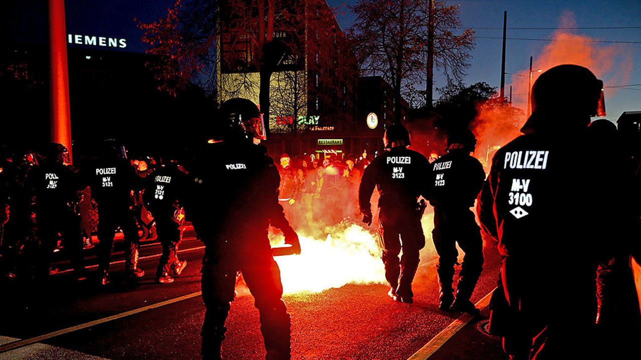 Fire in the streets! Protesters threw incendiary devices. Policemen back away from the flames