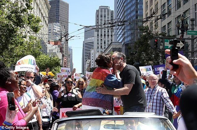 Emhoff and Harris seem devoted. A video of him awkwardly dancing dad in the San Francisco Pride Parade last year ends with her planting a big kiss on his lips (pictured)